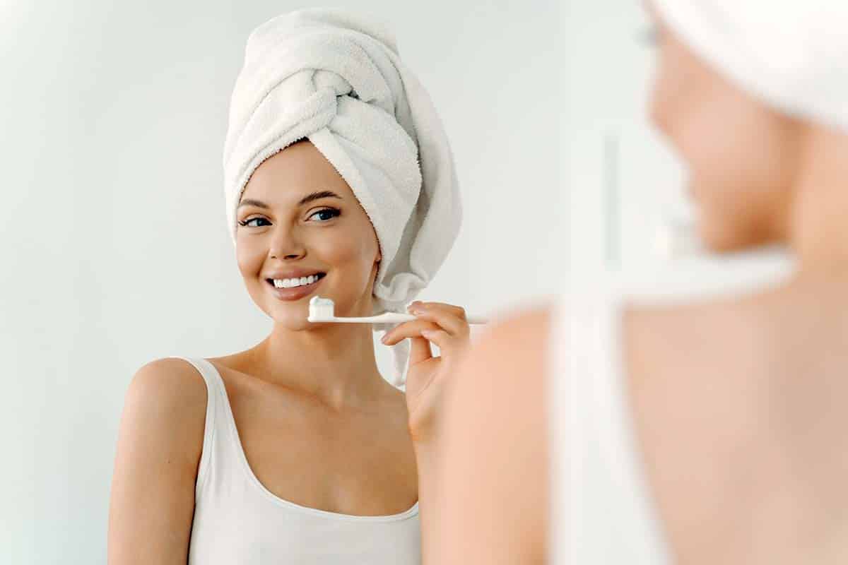 woman using teeth whitening toothpaste
